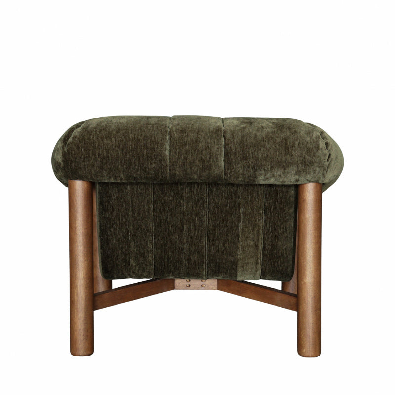 An upholstered bench with a rounded, tufted seat cushion in dark olive green velvet, supported by four tapered wooden legs and a matching wooden footrest.