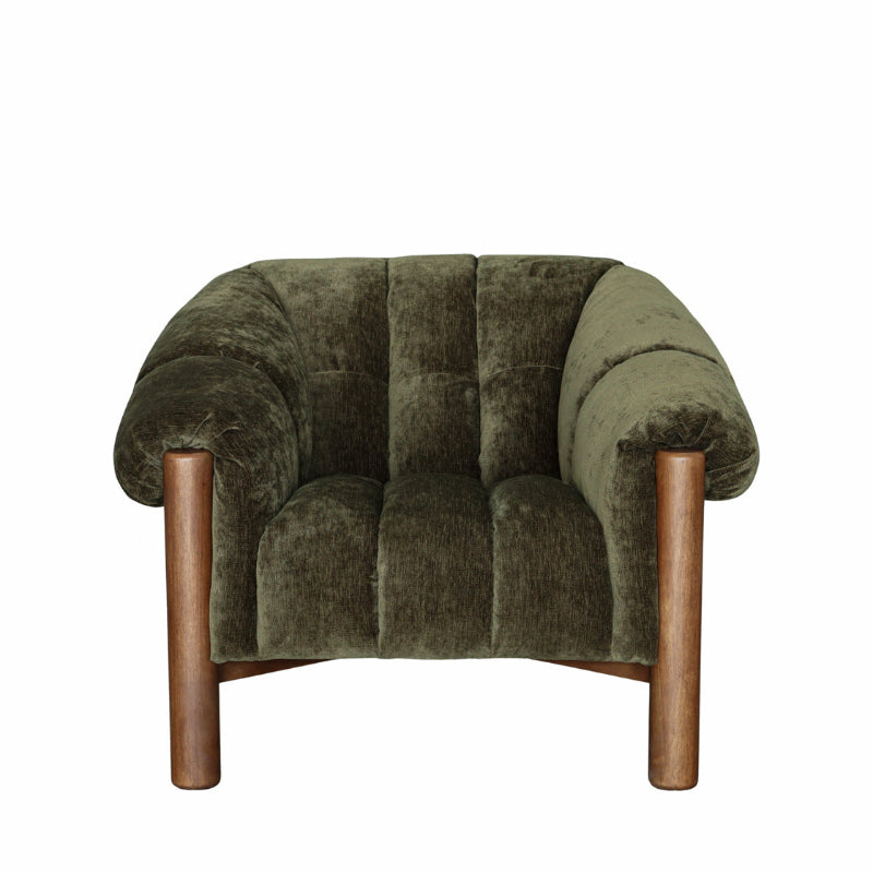 An armchair upholstered in olive green velvet with a tufted backrest and curved arms, supported by four cylindrical wooden legs, shown against a plain white background.