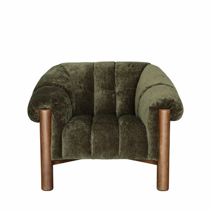 An armchair upholstered in olive green velvet with a tufted backrest and curved arms, supported by four cylindrical wooden legs, shown against a plain white background.