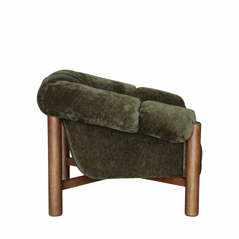 An upholstered accent chair with a plush, dark olive green velvet fabric and a natural wood frame, shown from a three-quarters angle against a solid white background.