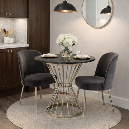 Dining area with a round table and two chairs in a kitchen setting.