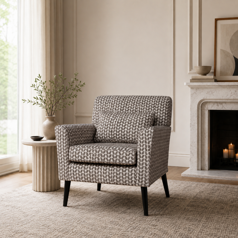 Patterned armchair in a living room with a fireplace and side table.