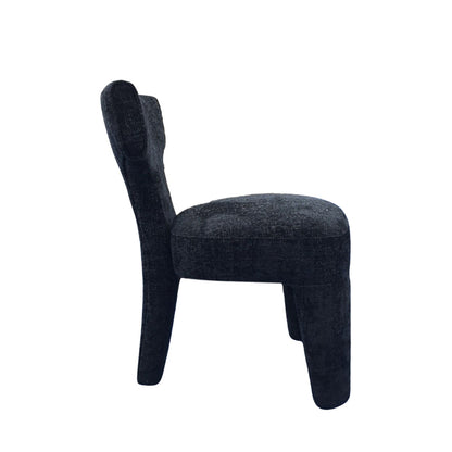 A modern upholstered dining chair with a dark charcoal textured fabric, featuring a curved backrest and tapered legs, shown from a side profile on a white background.