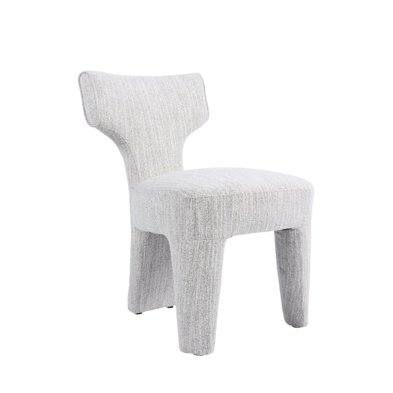 A modern upholstered side chair with a sculptural, curved backrest and chunky legs, upholstered in a light gray textured fabric, shown on a solid white background.