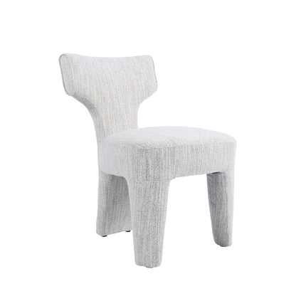 A modern upholstered side chair with a sculptural, curved backrest and chunky legs, upholstered in a light gray textured fabric, shown on a solid white background.