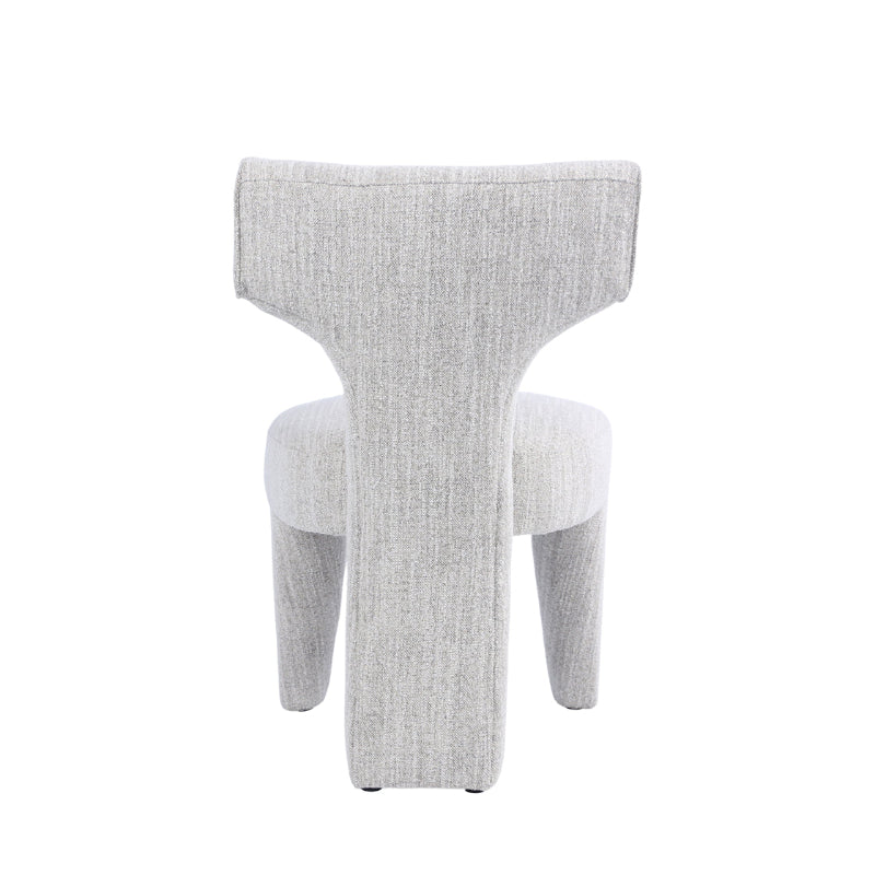 A modern sculptural upholstered chair in a light gray textured fabric, shown from the back against a plain white background.