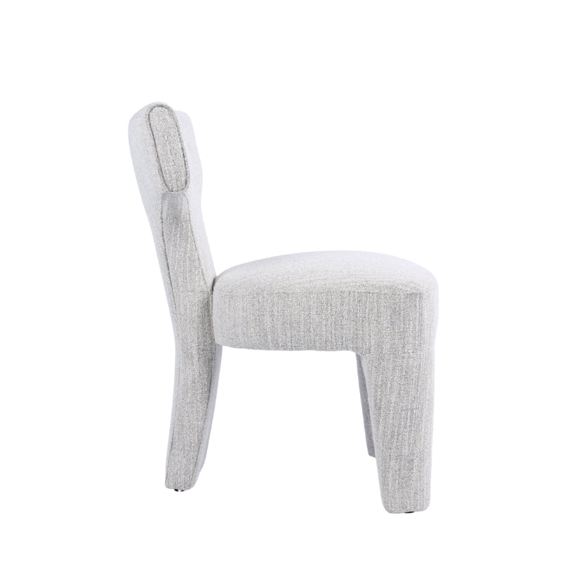 A light gray upholstered dining chair with a rounded backrest and tapered legs, shown from a side profile view against a solid white background.
