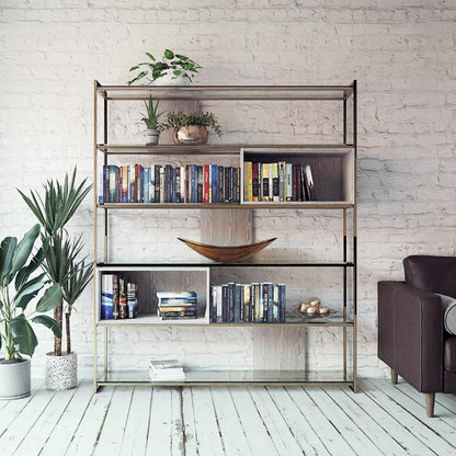 Bookshelf with books and decor items against a white brick wall.