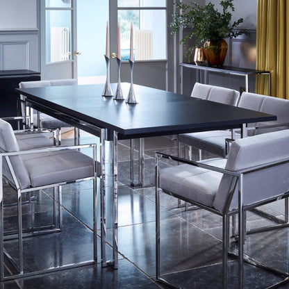 Modern dining room with a black table and gray chairs in a well-lit room.