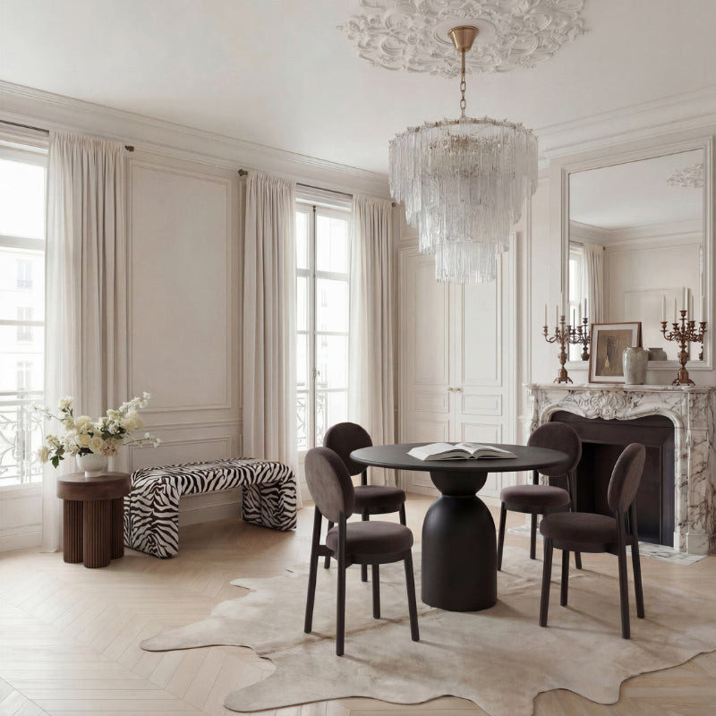 Elegant dining room with a chandelier, table, and chairs.