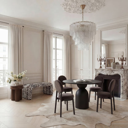 Elegant dining room with a chandelier, table, and chairs.