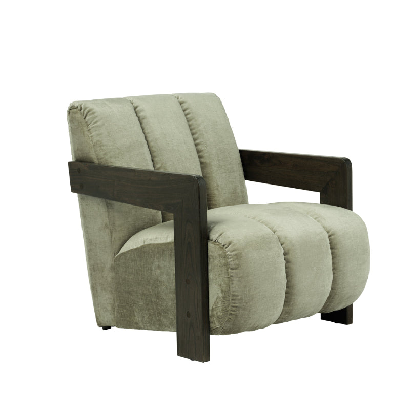 A modern low-profile armchair with a chunky dark wood frame and thick, segmented tufted cushions upholstered in a textured light sage green fabric, shown against a plain white background.