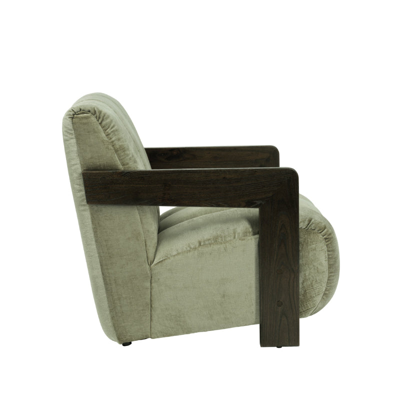 A modern accent chair featuring a dark brown wooden frame and a light sage green textured fabric upholstery, shown from a side profile on a white background.