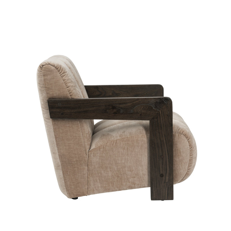 A modern accent chair with a beige textured fabric seat and back, featuring thick dark brown wooden armrests, shown from a side profile on a white background.