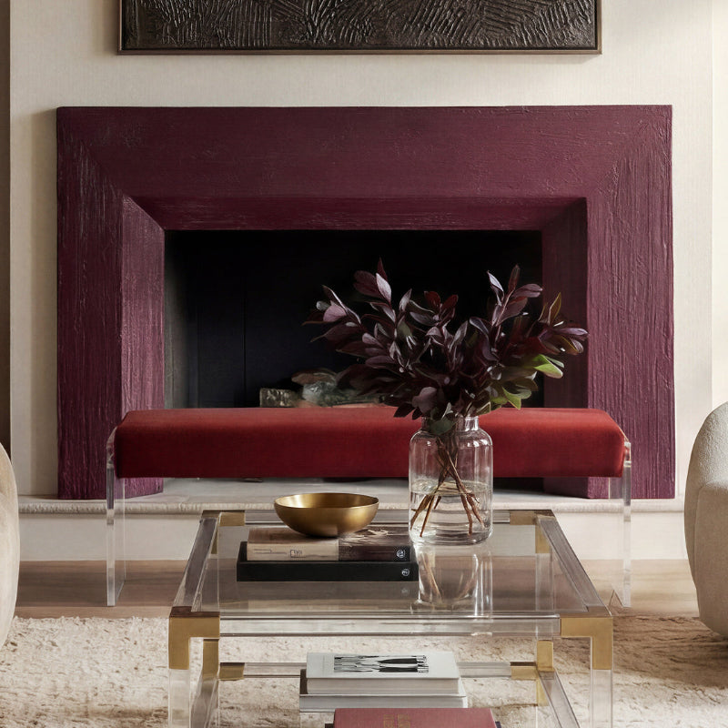 Living room with a fireplace, coffee table, and decorative items.