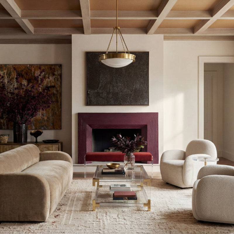 Modern living room with beige sofa, armchairs, and a purple fireplace.