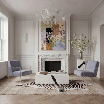 Living room with marble fireplace, gray chairs, and decorative elements.