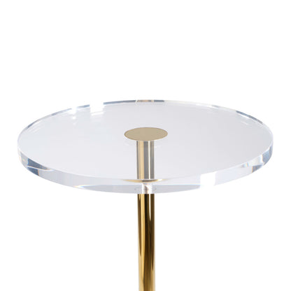 Round glass table with a gold metal base on a white background