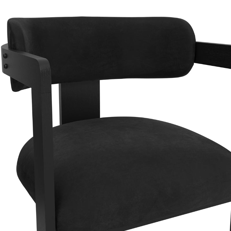 Close-up of a black dining chair with armrests on a white background