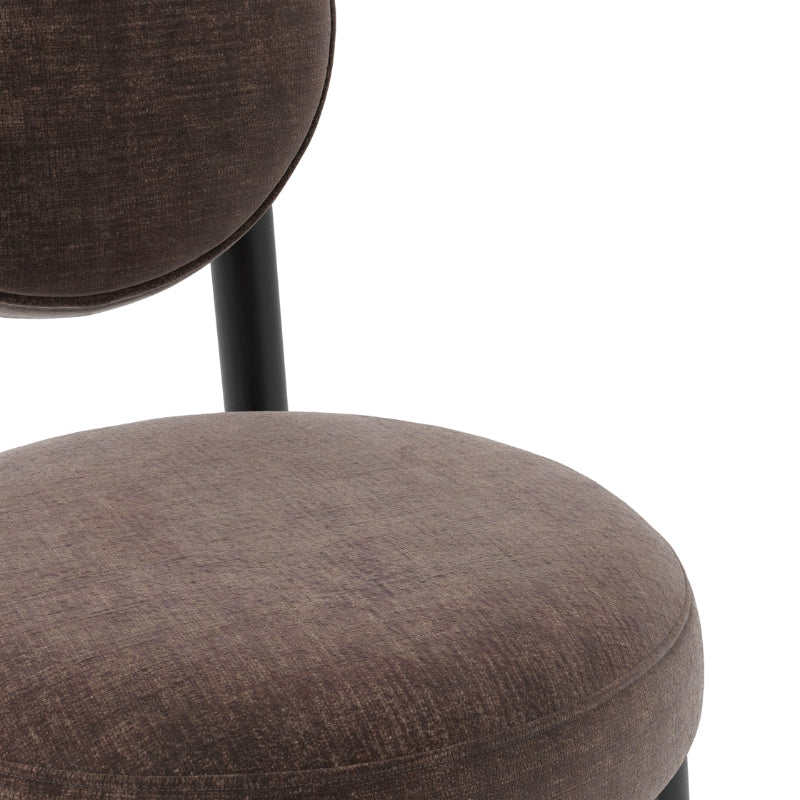 Brown upholstered chair with a white background