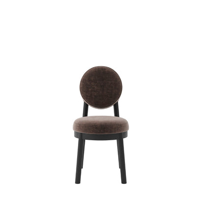 A modern dining chair with a round upholstered backrest and seat cushion in a dark brown velvet fabric, supported by a black metal frame, shown against a plain white background.