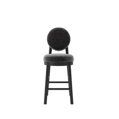 A modern bar stool with a round upholstered backrest and seat cushion in a dark charcoal gray fabric, supported by a slim black wooden frame with footrests, shown against a plain white background.