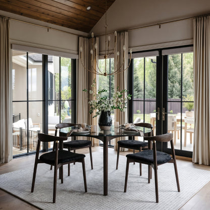 Modern dining room with a large window and chandelier