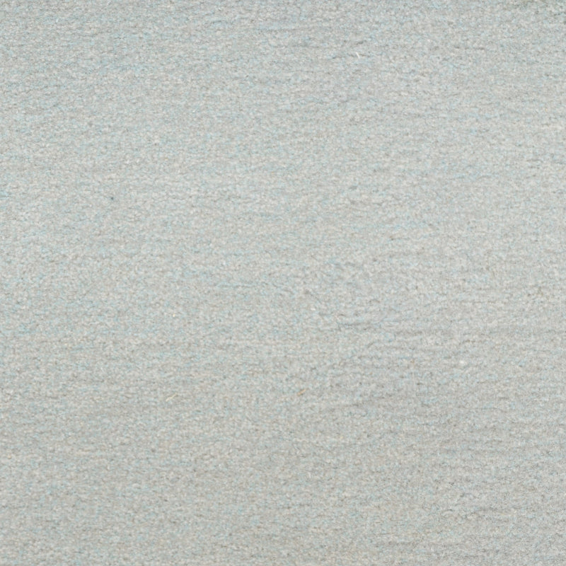 A close-up texture shot of a light gray, heathered fabric or material surface.
