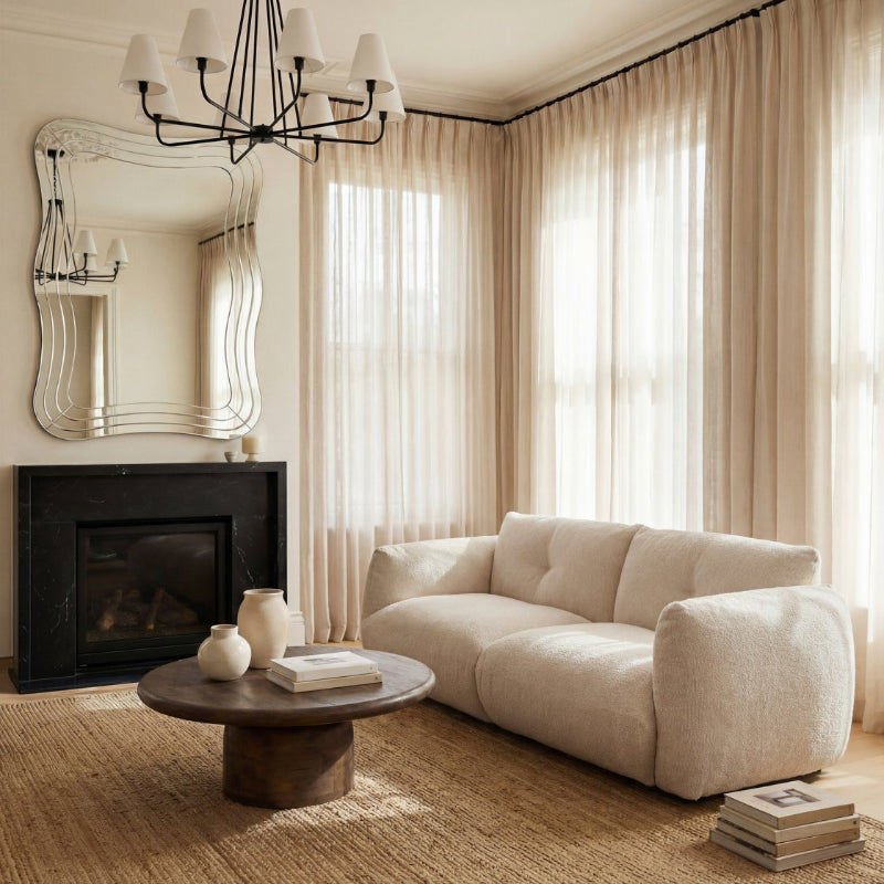 Living room with beige sofa, coffee table, and decorative items.