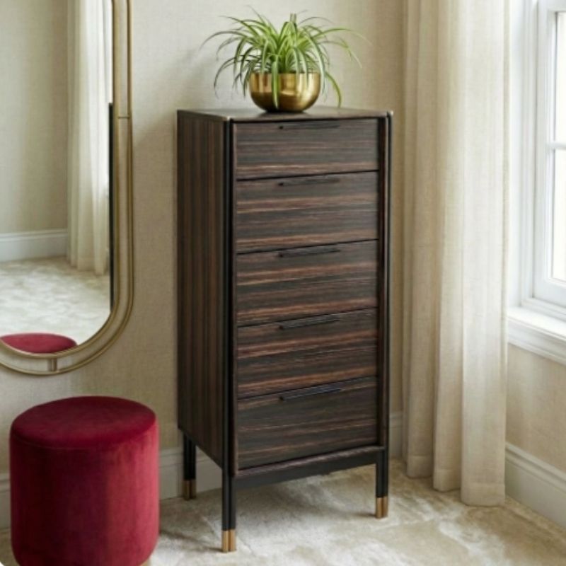 Wooden chest of drawers with a plant on top in a room with a mirror and red stool.