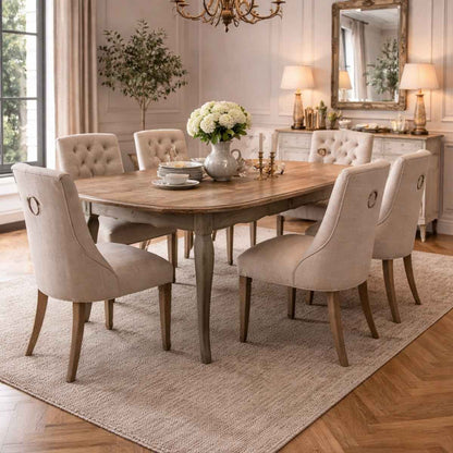 Dining room with wooden table and beige chairs in a well-lit room.