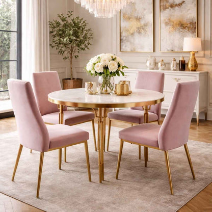 Dining room with round marble table and pink chairs in a stylishly decorated room.