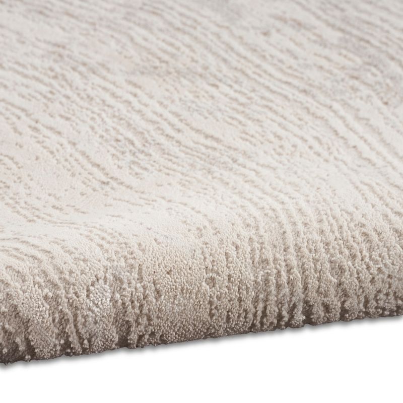Close-up of a textured beige carpet corner on a white background