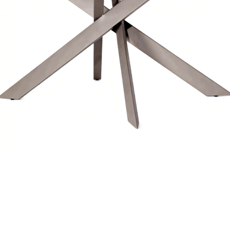 Close-up of a modern metal table base with intersecting angular legs in a brushed silver finish on a white background.