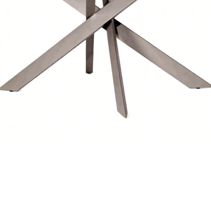 Close-up of a modern metal table base with intersecting angular legs in a brushed silver finish on a white background.