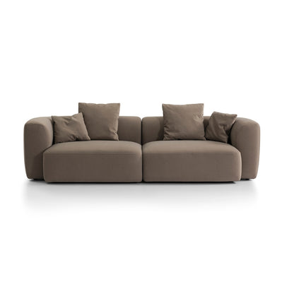 Low profile brown Sofa with four cushions on a white background