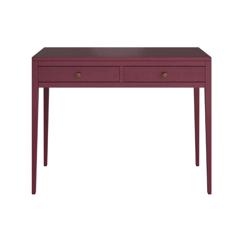Fuchsia console table against a blue wall with decorative items