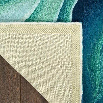 Close-up of a textured rug corner with green, beige, and blue colors.