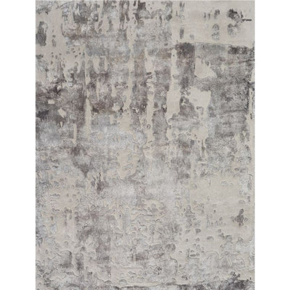 An abstract distressed pattern rug featuring a textured, weathered design in shades of gray, off-white, and charcoal.