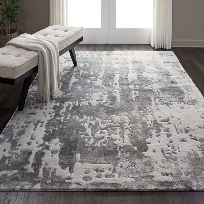 Gray and white textured area rug in a room with a bench and curtains.