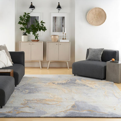 Modern living room with gray sofa, rug, and decorative items.