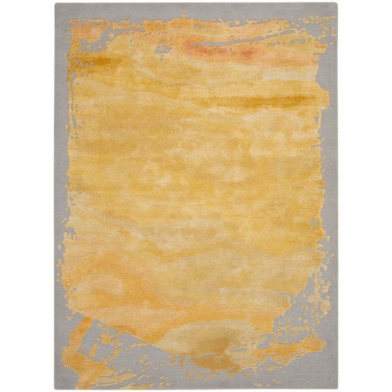 A rectangular area rug with a textured abstract design, featuring a large central golden-yellow watercolor-like wash bordered by a gray background with subtle orange and yellow accents.