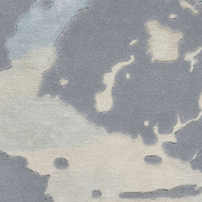 Abstract watercolor-style pattern in muted blue-gray and off-white tones, filling the frame.