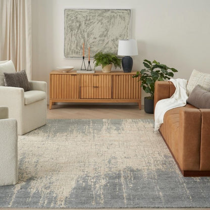 Living room with a brown sofa, beige armchair, wooden sideboard, and decorative elements.