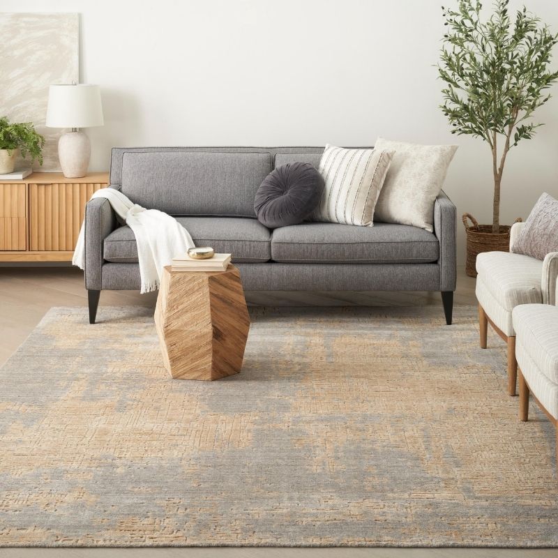 Living room with a gray sofa, wooden coffee table, and decorative pillows.