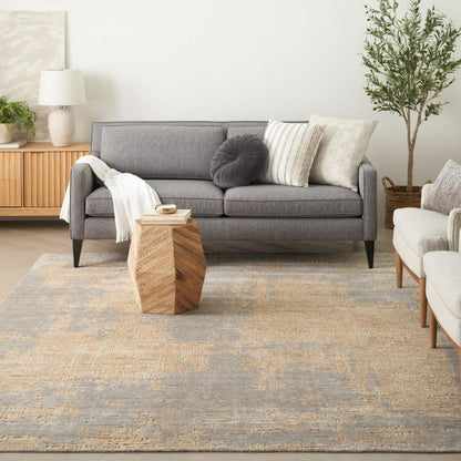 Living room with a gray sofa, wooden coffee table, and decorative pillows.