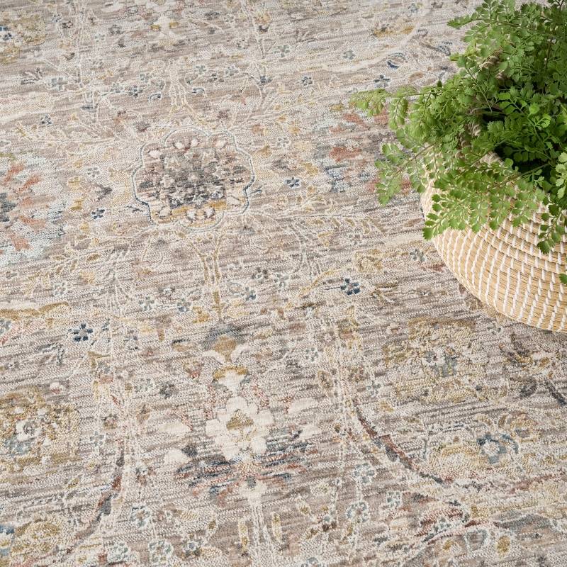 Patterned rug with a plant in a woven basket on top