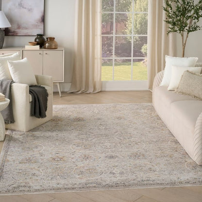 Living room with a large area rug, white furniture, and a large window.