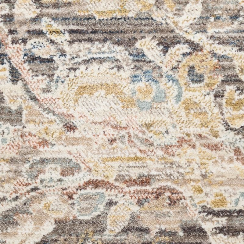 Close-up of a patterned rug with earthy tones.