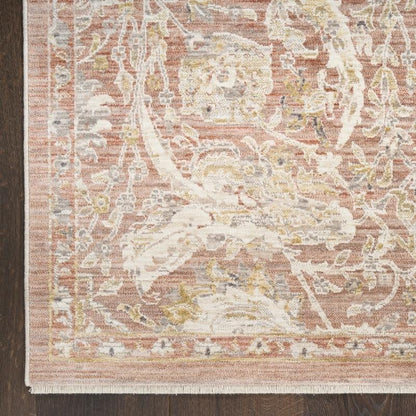 Close-up of a patterned rug with a neutral color palette on a wooden floor.